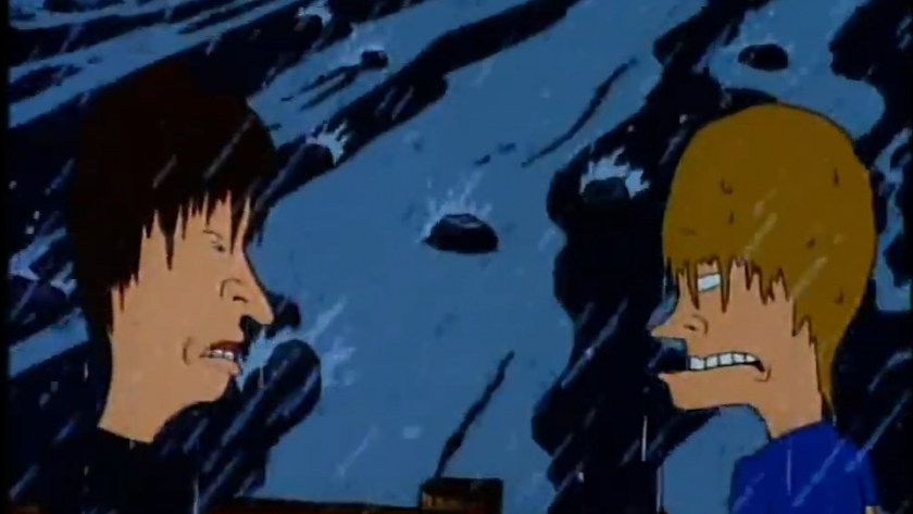 A screenshot from an episode of Beavis and Butt-head, "It's a Miserable Life" holiday special. This screenshot depicts Beavis and Butt-head standing on a wooden bridge in the rain, looking at each other. A river runs below the bridge.