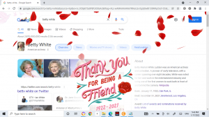 A screenshot of the Google search results page, dated January 17th, 2022 for "Betty White." Across the screen, red rose petals fall, and in script text, a small graphic reads "Thank you for being a friend, 1922-2021". 