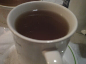 An old mug filled w/ some warm White Ginger Pear tea from Teabloom.