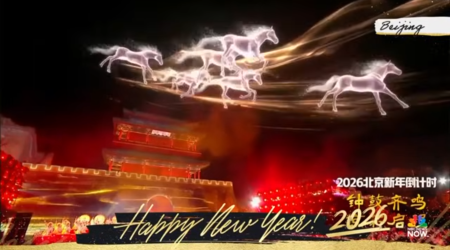 Screenshot from NBC News Now Fireworks Around the World, with footage from New Years Eve 2026 in Beijing, China. A light show in reds and yellows fills the screen, with white holographic horses galloping across the screen. Happy New Year 2026!